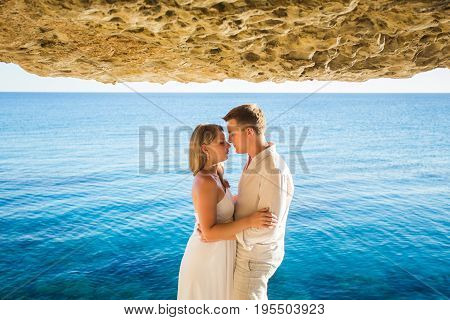 Romantic dating. Young loving couple walking together by the beach enjoying sea.