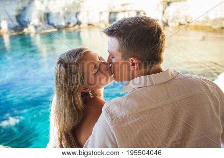 Romantic dating. Young loving couple walking together by the beach enjoying sea.