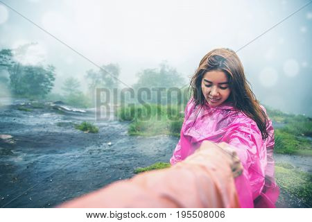 Lover Men and women Asia travel relax. walk in the forest rainy season. Walking hand. puhinrongkla Thailand