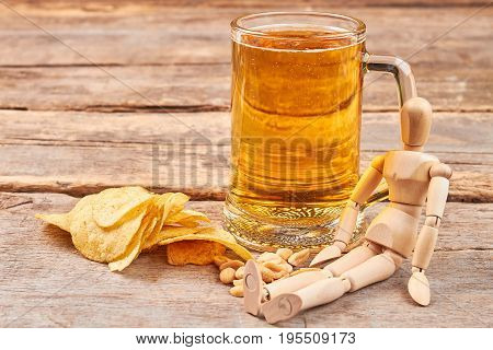 Human wooden dummy and beer. Concept of beer addiction.