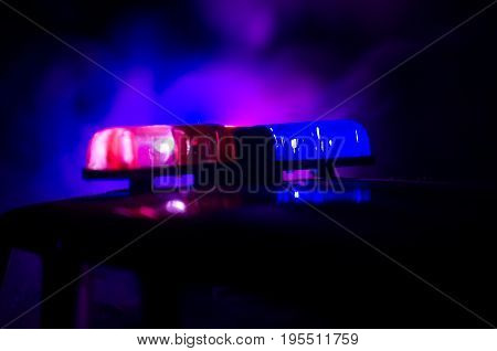 Red Light Flasher Atop Of A Police Car. City Lights On The Background. Police Government Concept