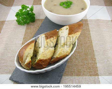 Lye baguette with herb butter and porcini mushroom cream soup