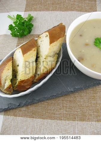 Lye baguette with herb butter and porcini mushroom cream soup