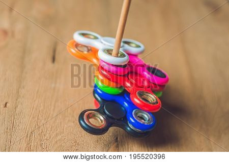 Colored Fidget Spinners Stress Relieving Toy On Wooden Background