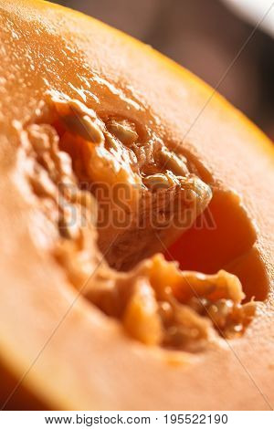 Half of ripe melon close up on blurred background.