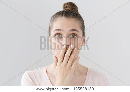 Indoor Shot Of Beautiful Teenage Girl Isolated On Gray Background Dressed In Light Pink Top, Coverin