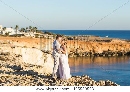 Romantic dating. Young loving couple walking together by the beach enjoying sea.