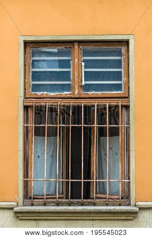 Front view vintage lattice window on a beige wall with scratches