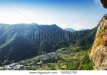 The village of Shanglingyancun and a terraced tea garden surrounded by the mountains in the Fangdong scenic area of Yandangshan located in Zhejiang province China.