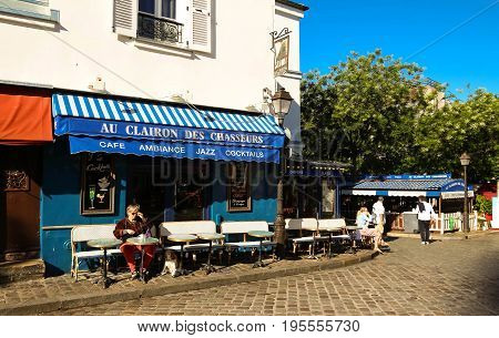 PARIS , France- July 14, 2017: View of typical paris cafe in Paris. Montmartre area is among most popular destinations in Paris, Au clairon de chasseur is a typical cafe.