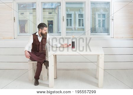 Man With Glass And Bottle Of Wine On Table