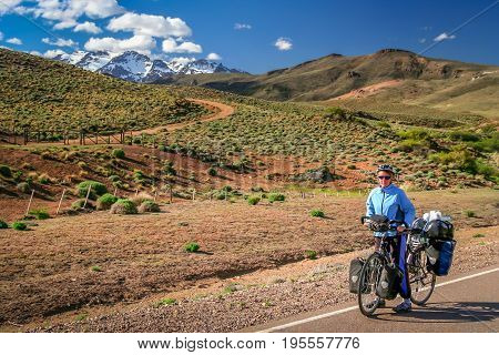 Woman cycling on the famous national Ruta 40 
 quarenta in central Argentina