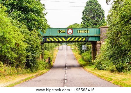 Day view of UK motorway highway under railway bridge.