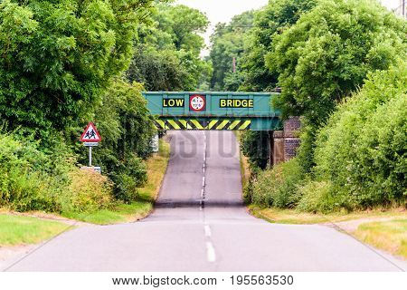 Day view of UK motorway highway under railway bridge.