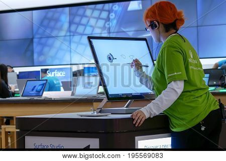 Burnaby, BC, Canada - March 07, 2017 : Clerk painting on new computer at Microsoft store in Burnaby BC Canada