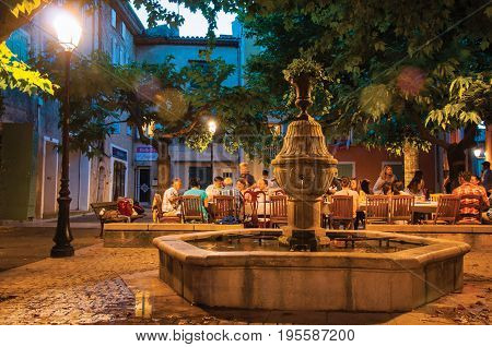 Rians, France - July 08, 2016. People dining in a square restaurant in the early evening, at the lovely village of Rians. Located in Var department, Provence region, in southeastern France.