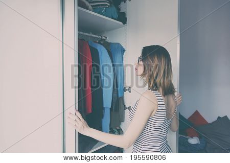 Young Rednead Girl Choosing A Clothes
