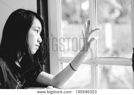 Depress And Hopeless Girl With Absent Minded Looking Outside