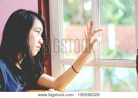 Depress And Hopeless Girl With Absent Minded Looking Outside