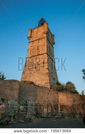 View of the clock tower made of stone and with a bell, stands on top of the hill dominating the whole gracious city of Draguignan. Located in the Provence region, Var department, southeastern France
