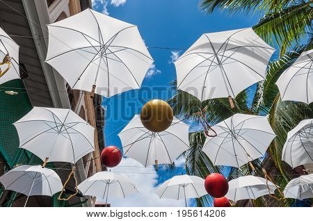Port Louis Mauritius - December 25 2015: Umbrella art display in street at Caudan Waterfront Port Louis Mauritius.