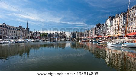 Editorial Honfleur, France - July 05, 2017: Honfleur harbour in France's Normandy region, sited on the estuary where the Seine river meets the English Channel