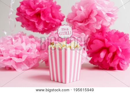 It's A Girl Sign In A Popcorn Bag At The Baby Shower Party.  Paper Flowers Background.  Baby Shower 