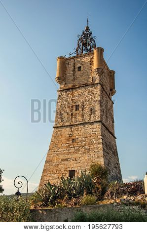 View of the clock tower made of stone on top of the hill with vegetation in the lively and gracious town of Draguignan. Located in the Var department, Provence region, southeastern France