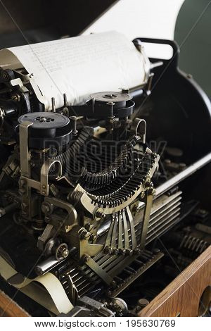 Detail of an antique typewriter build in wooden box