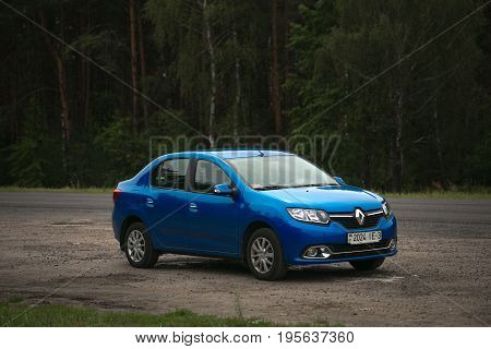 GOMEL BELARUS - JULY 15 2017: RENO LOGAN blue car parked in a dark pine forest.