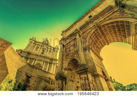 Arch of Septimius Severus and church of Santi Luca e Martina at the Roman Forum. Rome Italy at morning light.
