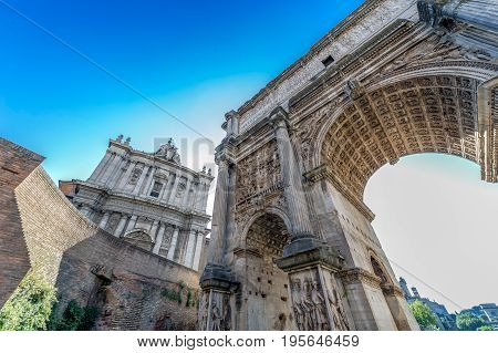 Arch of Septimius Severus and church of Santi Luca e Martina at the Roman Forum. Rome Italy at morning light.