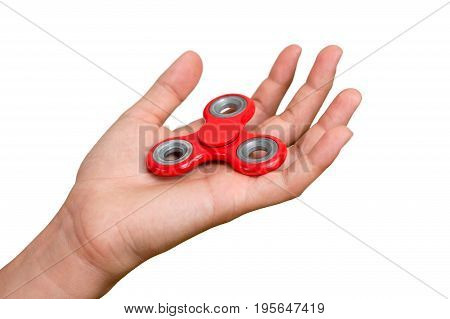 Red hand spinner. Boy playing a popular toy fidget spinner in his hand. Stress relief. Anti stress and relaxation adhd attention fad boy concept