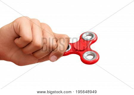 Red hand spinner. Boy playing a popular toy fidget spinner in his hand. Stress relief. Anti stress and relaxation adhd attention fad boy concept