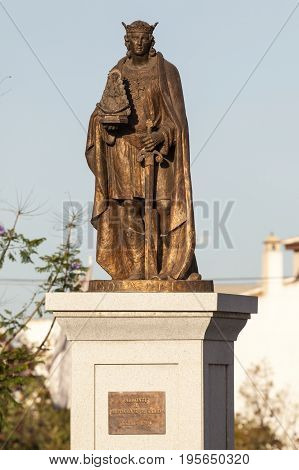 Almonte Spain - June 3 2017: Bronze statue of a pilgrim holding a figure of Madonna of El Rocio. Almonte Andalusia Spain