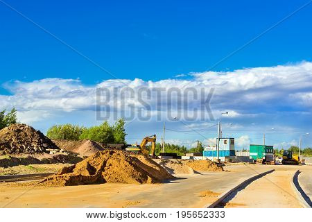 Mountains of white sand lie on side of road. Construction of high-speed ring road around Krasnoe Selo Saint Petersburg. Civil and industrial construction. Russia