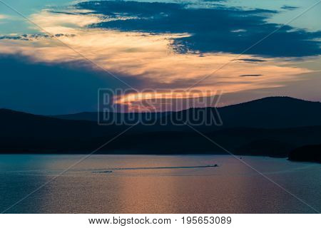 Lake Turgoyak at sunset from the height of the mountains. The lake is located between the mountains of the Ural range.