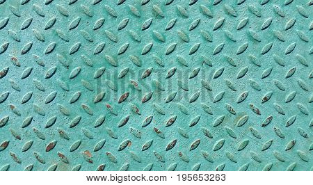 Texture of old metal diamond plate covered with green paint