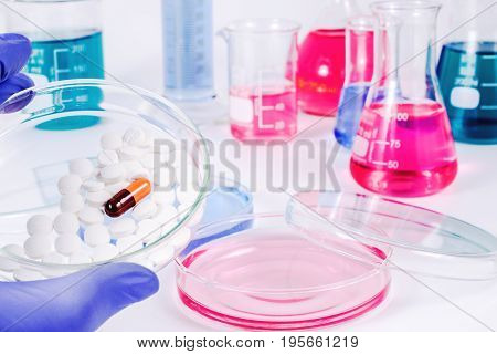 Scientist analyzing pills in medical laboratory. Analysis of medicaments in laboratory. Medical Research and diseases Science.