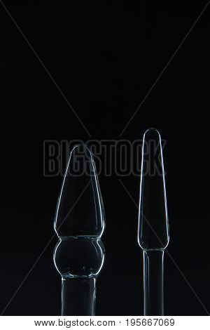 Big Butt plug transparent glass on a black background