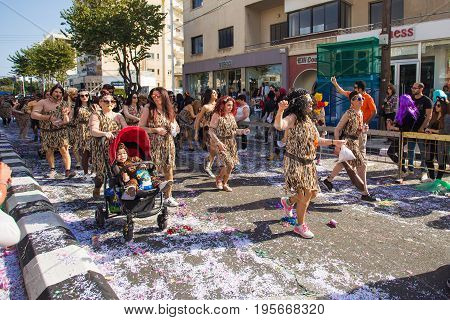 LIMASSOL, CYPRUS - FEBRUARY 26: Carnivalists in a silver cylinder hats joyfully follow the Limassol Municipality Band during the annual Carnival Parade, February 26, 2017 in Limassol.