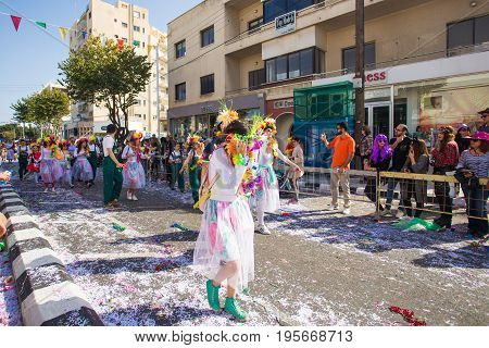 LIMASSOL, CYPRUS - FEBRUARY 26: Carnivalists in a silver cylinder hats joyfully follow the Limassol Municipality Band during the annual Carnival Parade, February 26, 2017 in Limassol.