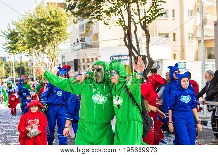 LIMASSOL, CYPRUS - FEBRUARY 26: Carnivalists in a silver cylinder hats joyfully follow the Limassol Municipality Band during the annual Carnival Parade, February 26, 2017 in Limassol.