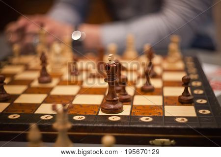 wood chess pieces on board game. vintage background