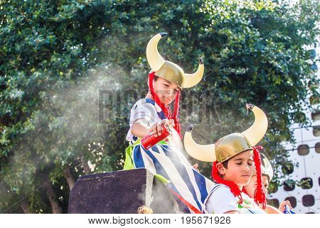 LIMASSOL, CYPRUS - FEBRUARY 26: Carnivalists in a silver cylinder hats joyfully follow the Limassol Municipality Band during the annual Carnival Parade, February 26, 2017 in Limassol.