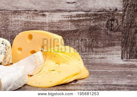 Different type of cheese on wooden background. Gourmet food apetizer