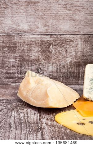 Different type of cheese on wooden background. Gourmet food apetizer