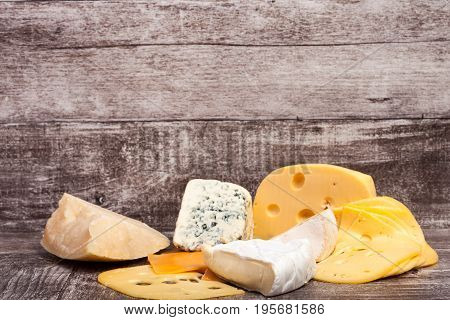 Different type of cheese on wooden background. Gourmet food apetizer
