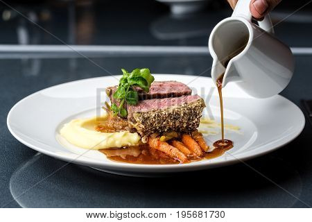 medium done grilled tuna steak in batter served with the baby carrot and mashpotato