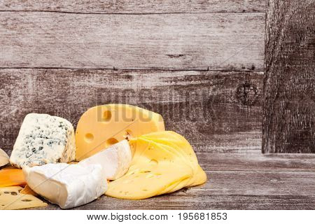 Different type of cheese on wooden background. Gourmet food apetizer